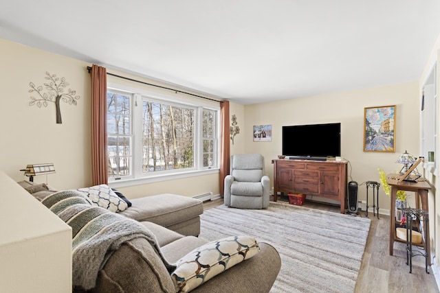 living area with light wood-type flooring, baseboards, and a baseboard radiator