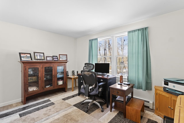 office space with a baseboard radiator and baseboards