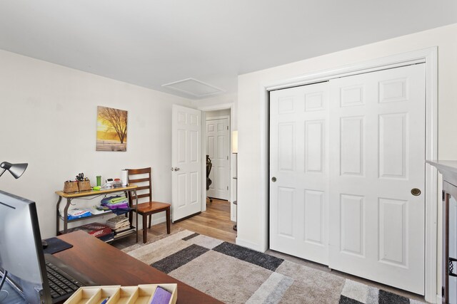 office space with attic access and wood finished floors