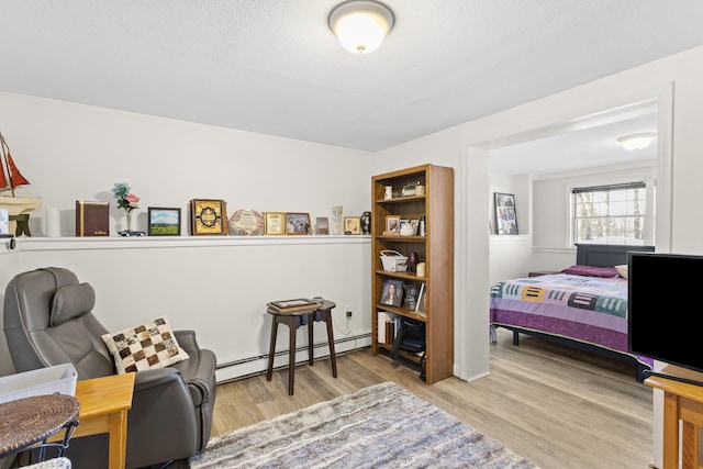 interior space with wood finished floors and baseboard heating