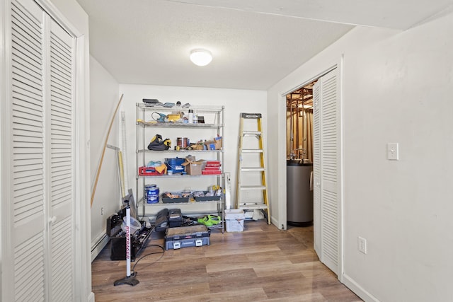 interior space with a baseboard heating unit and water heater