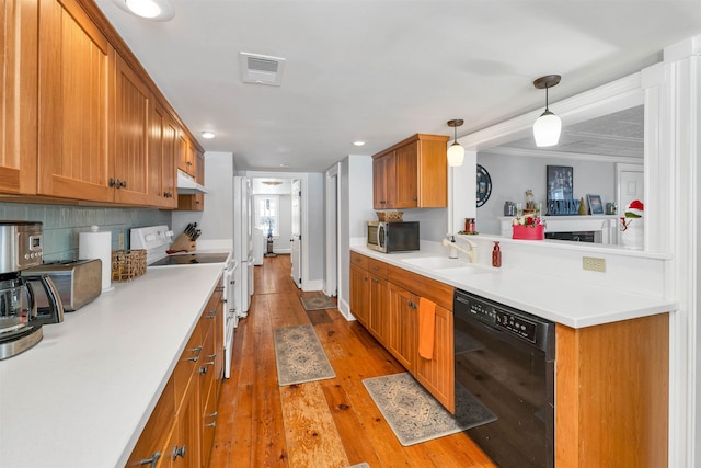 kitchen with visible vents, electric stove, a sink, stainless steel microwave, and black dishwasher