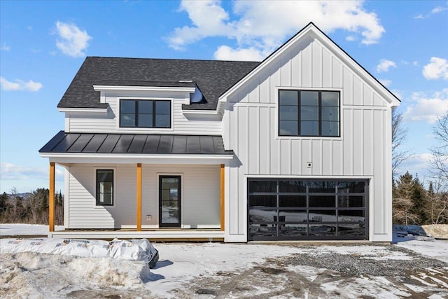 modern farmhouse featuring roof with shingles, a standing seam roof, a porch, an attached garage, and board and batten siding