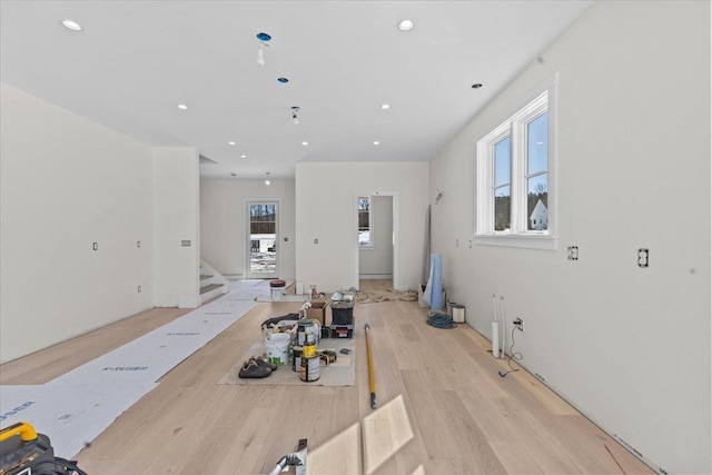 workout room with light wood finished floors, plenty of natural light, and recessed lighting