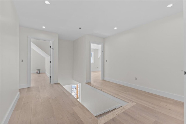 corridor with recessed lighting, baseboards, and light wood-style flooring