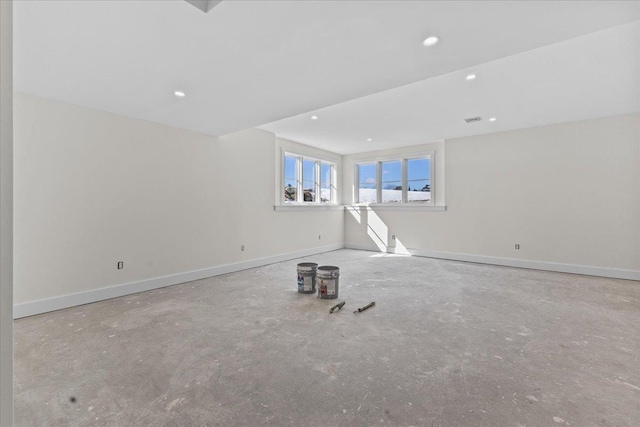 unfurnished room featuring recessed lighting and baseboards