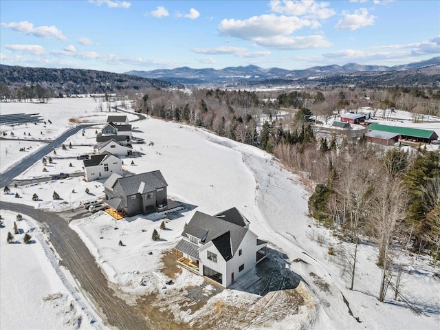 snowy aerial view with a mountain view