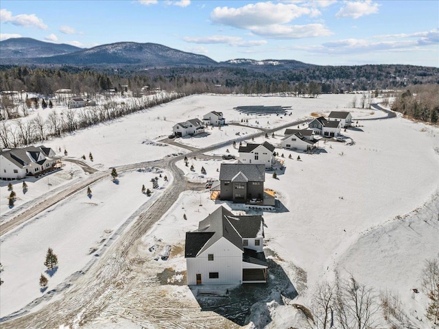 snowy aerial view with a mountain view