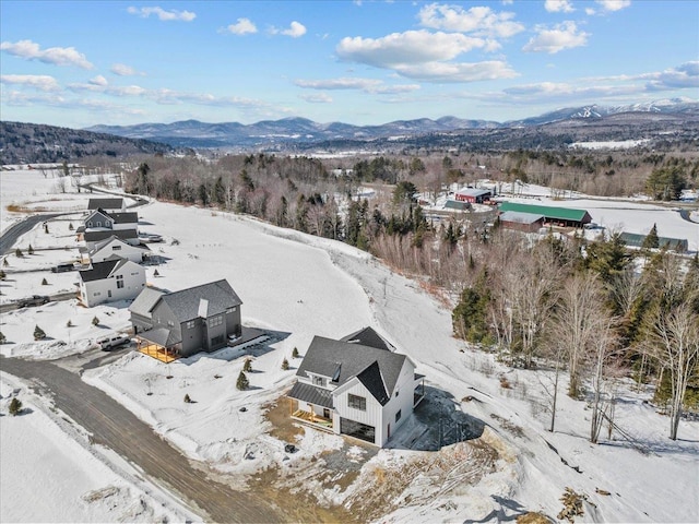 snowy aerial view with a mountain view