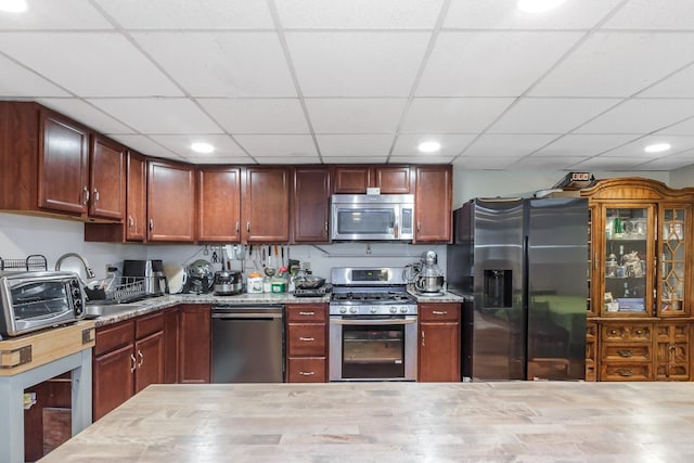 kitchen with a drop ceiling, stainless steel appliances, recessed lighting, and a toaster