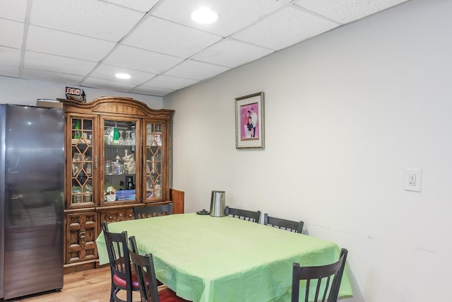 dining room featuring recessed lighting, a drop ceiling, and wood finished floors