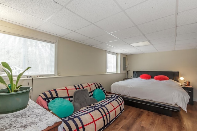 bedroom featuring a paneled ceiling and wood finished floors