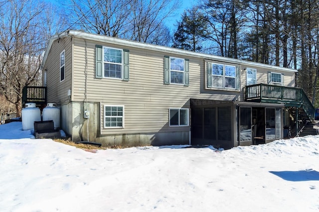 view of front of house featuring stairway and a sunroom