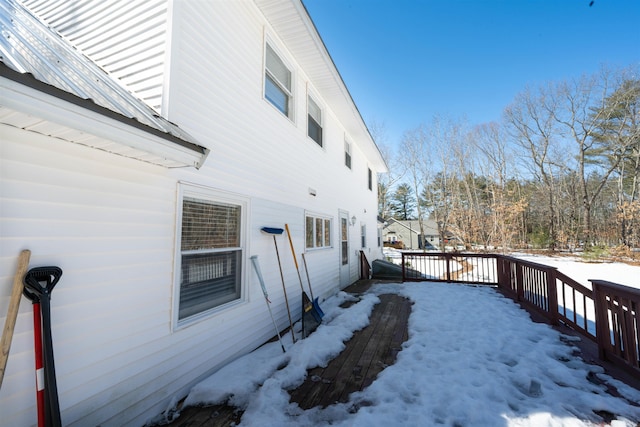 snow covered property with a wooden deck