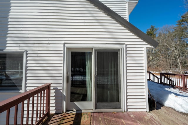 view of exterior entry with a wooden deck