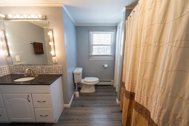 bathroom with crown molding, a baseboard heating unit, baseboards, toilet, and wood finished floors