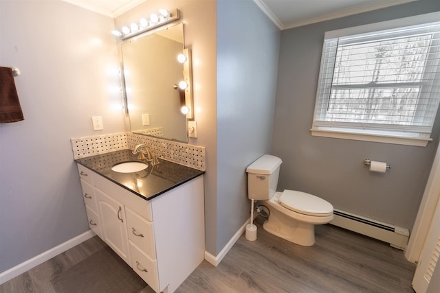 bathroom featuring a baseboard heating unit, crown molding, toilet, and wood finished floors