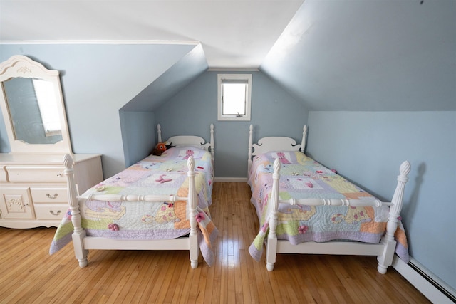 bedroom with lofted ceiling and hardwood / wood-style flooring