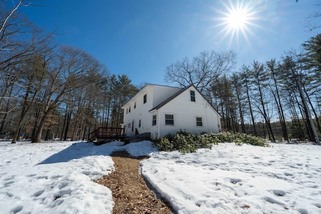 view of snow covered exterior with a deck