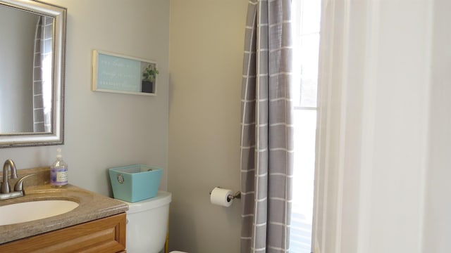 bathroom with toilet and vanity