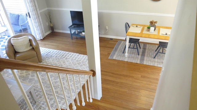 interior space with visible vents, wood finished floors, and baseboards