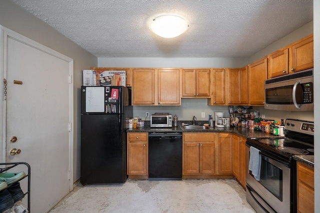 kitchen with dark countertops, black appliances, a toaster, a textured ceiling, and a sink