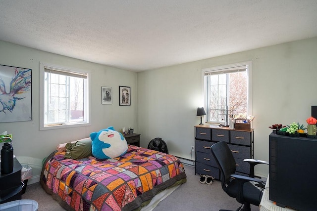 carpeted bedroom with multiple windows, a textured ceiling, and a baseboard heating unit