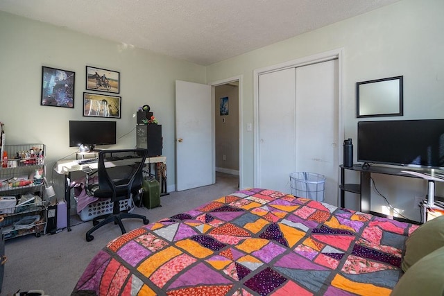 bedroom with a closet, carpet, and a textured ceiling