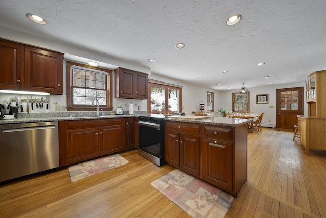 kitchen with a sink, range with electric stovetop, stainless steel dishwasher, a peninsula, and light wood finished floors