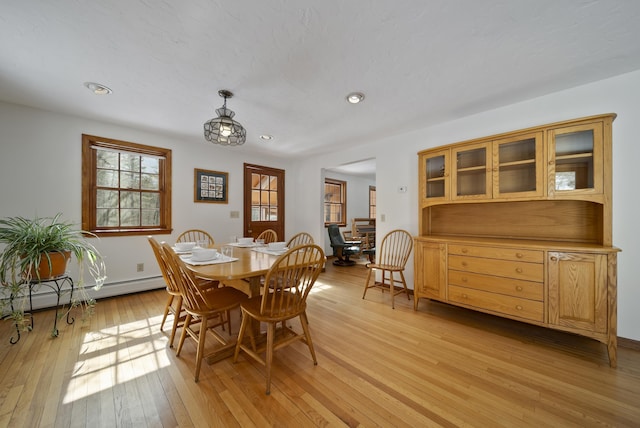 dining space with recessed lighting, light wood-style floors, and baseboard heating