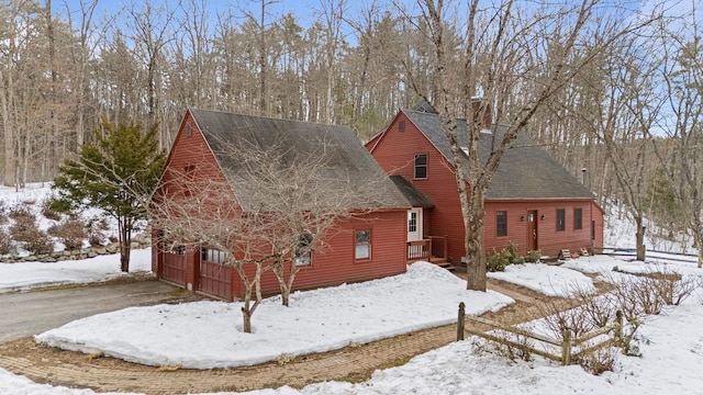 exterior space featuring a garage and roof with shingles