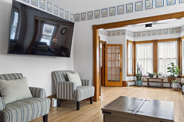 sitting room with wood-type flooring and a baseboard radiator