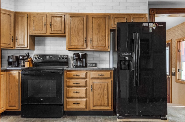 kitchen featuring black appliances, brown cabinets, and backsplash