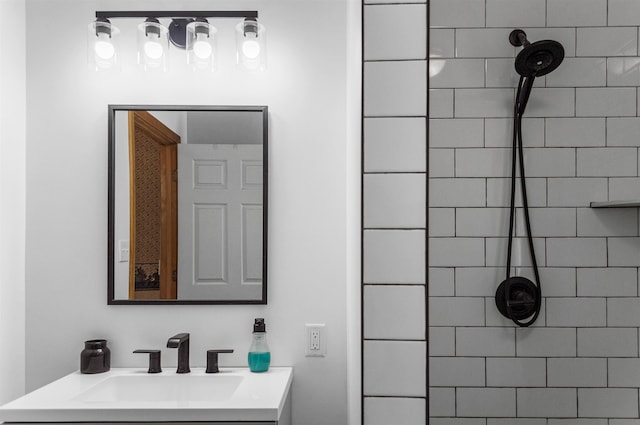 full bath with vanity and a tile shower