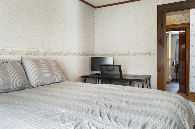 bedroom featuring wallpapered walls, crown molding, and wood finished floors