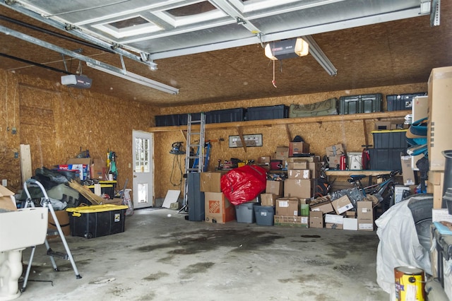 garage with a workshop area and a garage door opener