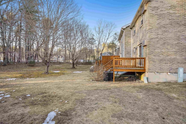 view of yard featuring cooling unit and a deck