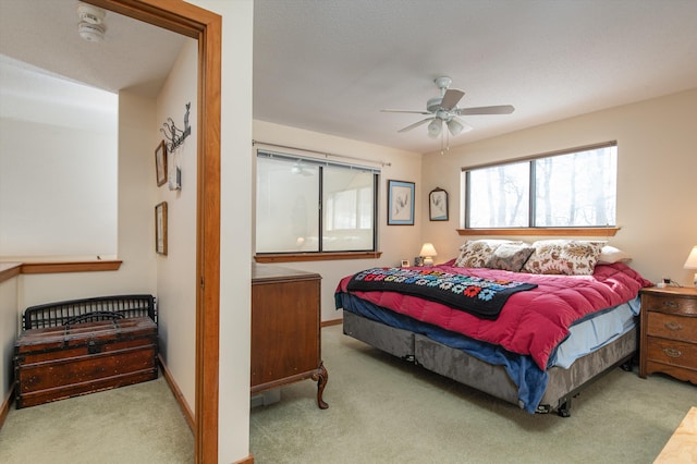 carpeted bedroom with baseboards and ceiling fan