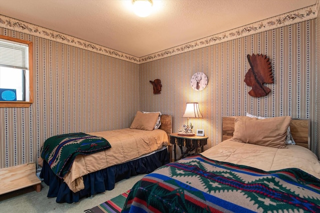 bedroom featuring a textured ceiling, wallpapered walls, and carpet floors