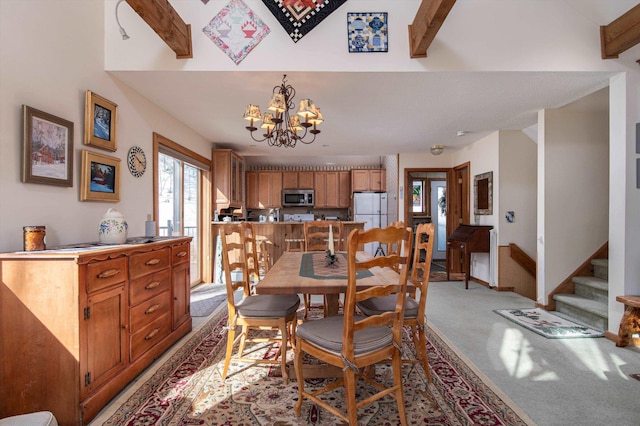 dining room with vaulted ceiling with beams, baseboards, stairway, light colored carpet, and a notable chandelier