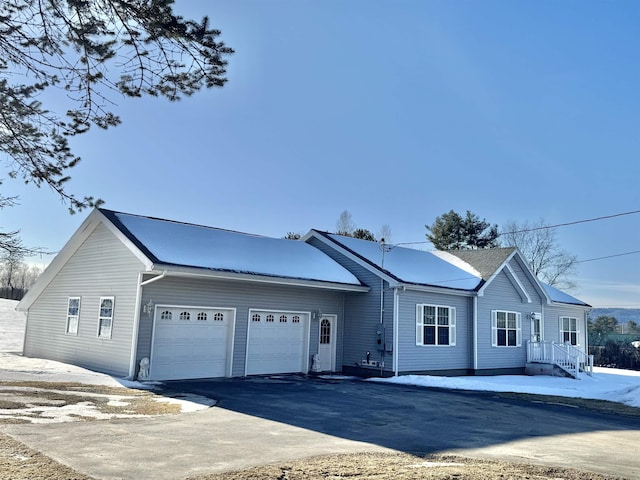 single story home with a garage and driveway