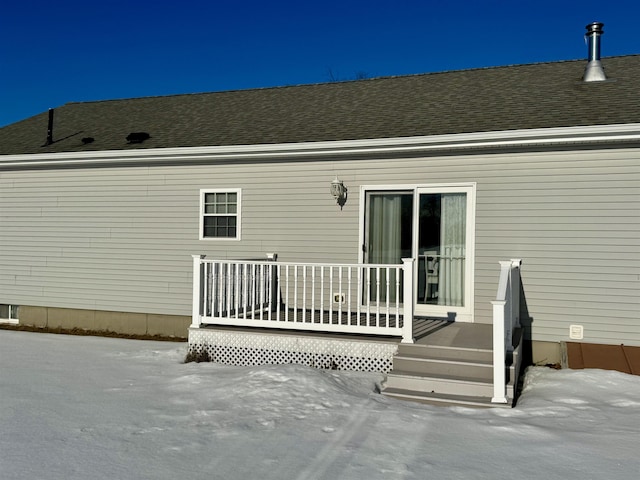 rear view of property with a deck and a shingled roof