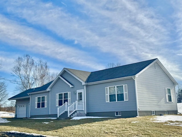 ranch-style house featuring an attached garage and a yard