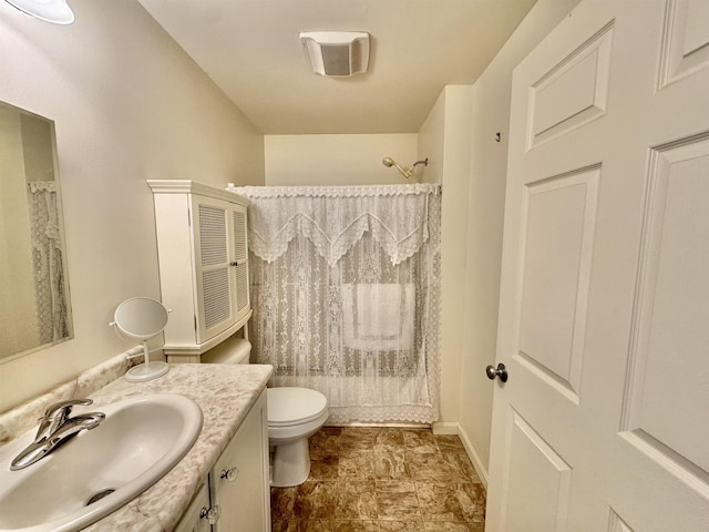 bathroom featuring toilet, curtained shower, and vanity