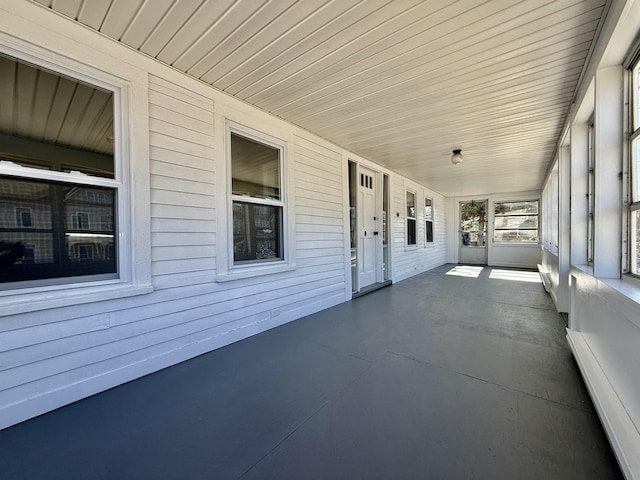 view of patio with covered porch and baseboard heating