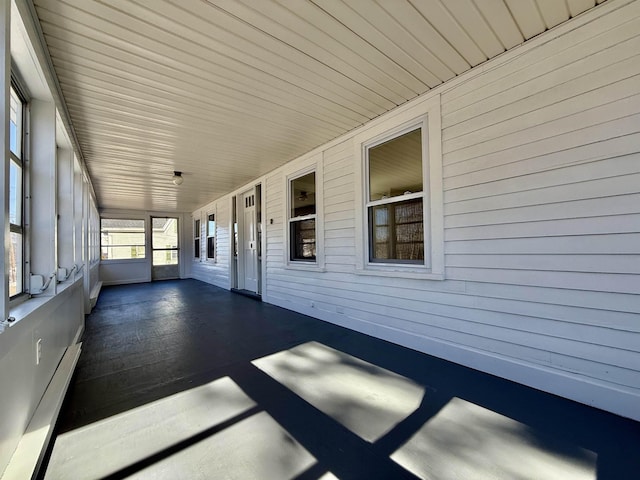 unfurnished sunroom with wooden ceiling