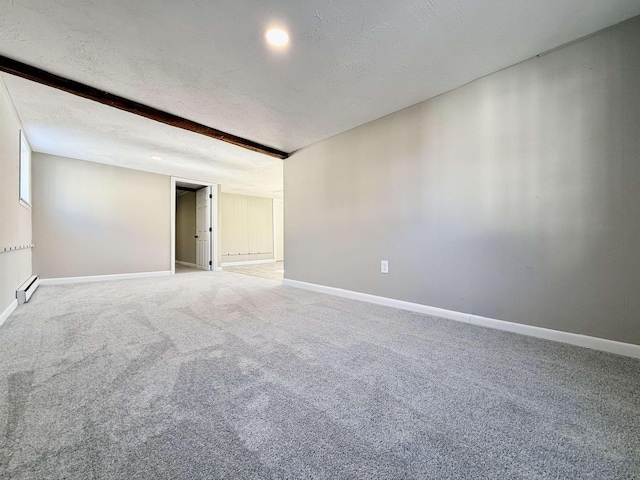 carpeted spare room with beam ceiling, a textured ceiling, a baseboard heating unit, and baseboards