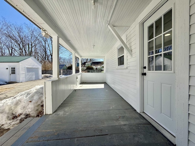 view of patio featuring a porch, an outbuilding, and a garage