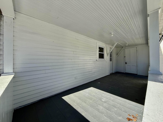 view of patio / terrace with a carport and a deck