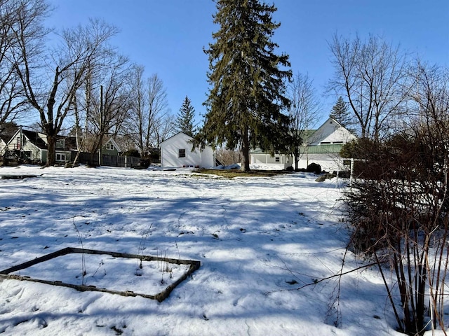 snowy yard with fence